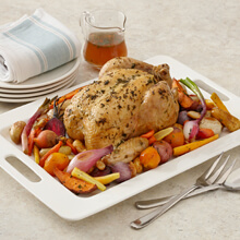 Roasted Chicken and Root Vegetables with gravy and a loaf of bread
